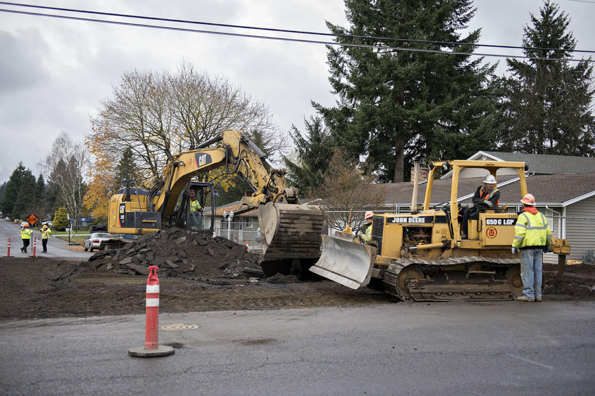 Construction crews work near the intersection of Northeast 94th Avenue and Northeast 96th Street on Nov. 24, 2015.