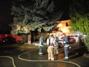 Vancouver firefighters respond to a second-story bathroom fire Monday night at this split-level house in the Parkside neighborhood in east Vancouver.