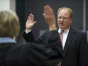 Clark County Superior Court Judge David Gregerson takes the oath of office from Judge Barbara Johnson during his swearing-in ceremony Monday at the Clark County Public Service Center.