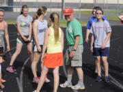 Bruce Flanagan, center, gathers the current edition of his long-running Flanagan Clan Girls Track Team for a workout last week in Woodland.