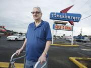 Bud Van Cleve, longtime president of the Northeast Hazel Dell Neighborhood Association, stands in front of the Hazel Dell landmark Steakburger restaurant on Highway 99.