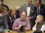 Vancouver City Councilor Jack Burkman, center, displays election results at Clark College's Gaiser Hall.