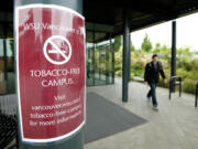 A student walks past a temporary sign Wednesday on the Washington State University Vancouver campus.