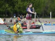 Jillian Cammer tries a stand-up paddle board at the 21st annual Spring Paddle Festival at Vancouver Lake on Saturday.