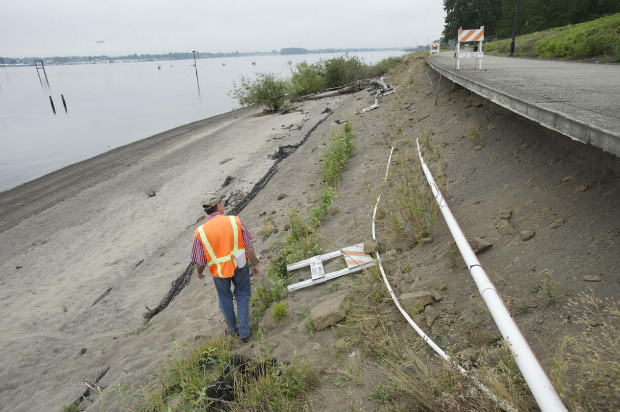 Mike Shaw, project manager for Keystone Construction of Ridgefield, gives a tour Thursday of a portion of the Waterfront Renaissance Trail in the Tidewater Cove area that was damaged by high waters in 2011. At top, a portion of the trail that was damaged.