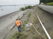 Mike Shaw, project manager for Keystone Construction of Ridgefield, gives a tour Thursday of a portion of the Waterfront Renaissance Trail in the Tidewater Cove area that was damaged by high waters in 2011. At top, a portion of the trail that was damaged.