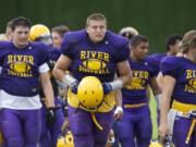 Columbia River's James Niemela, center, takes part in practice drills, Wednesday.