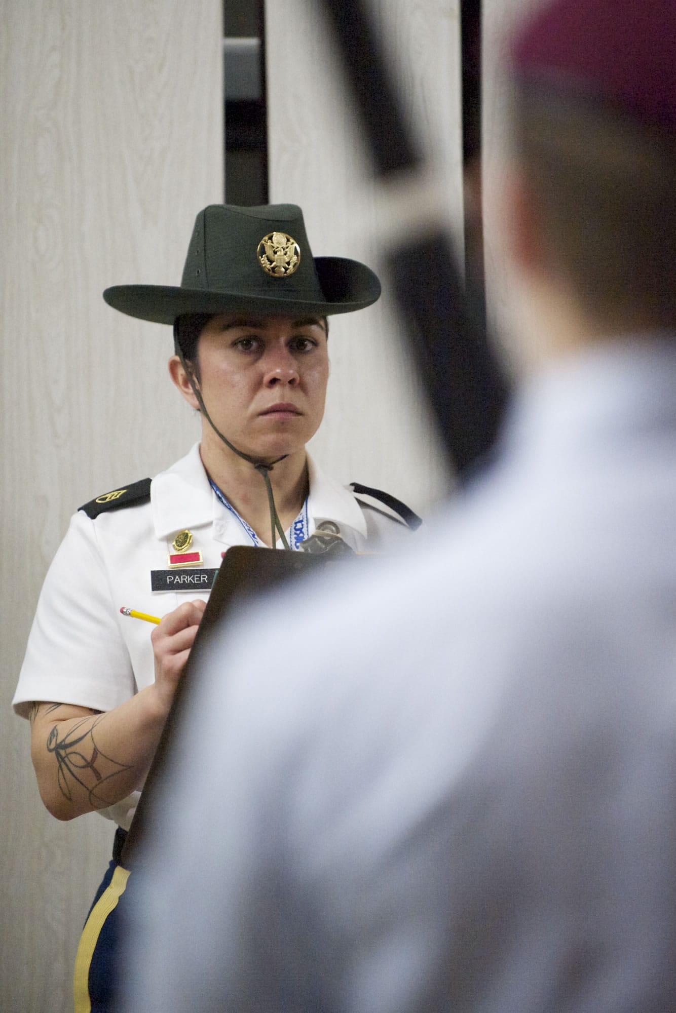 Army Reserve Drill Sergeant Victoria Parker judges the duals exhibition drill competition. Parker credits her involvement in her high school's Junior ROTC program for advancing her military career.