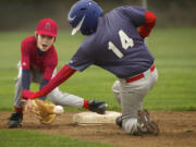 Angels shortstop Corbin Sarvela, 10, awaits the throw as Red Sox runner Cole Bain, 10, steals second base during Hazel Dell Little League's opening-day action.