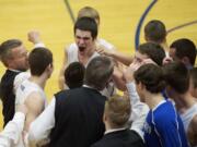 La Center's Austin Meyers celebrates with his team after beating Woodland at the boys 1A District Tournament at Kelso High School, Wednesday, February 13, 2013.