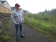 Ryan Erlewine stands in his Grass Valley neighborhood in Camas near the site of a proposed cell monopole.