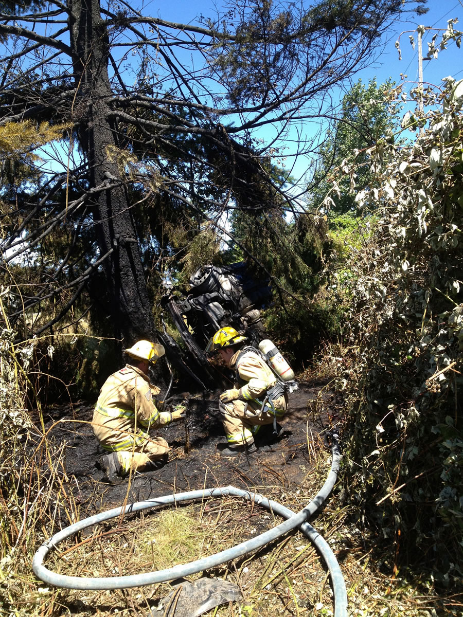 Firefighters and police couldn't locate the driver of this stolen Kia sedan after it crashed alongside Interstate 5 and caught on fire.