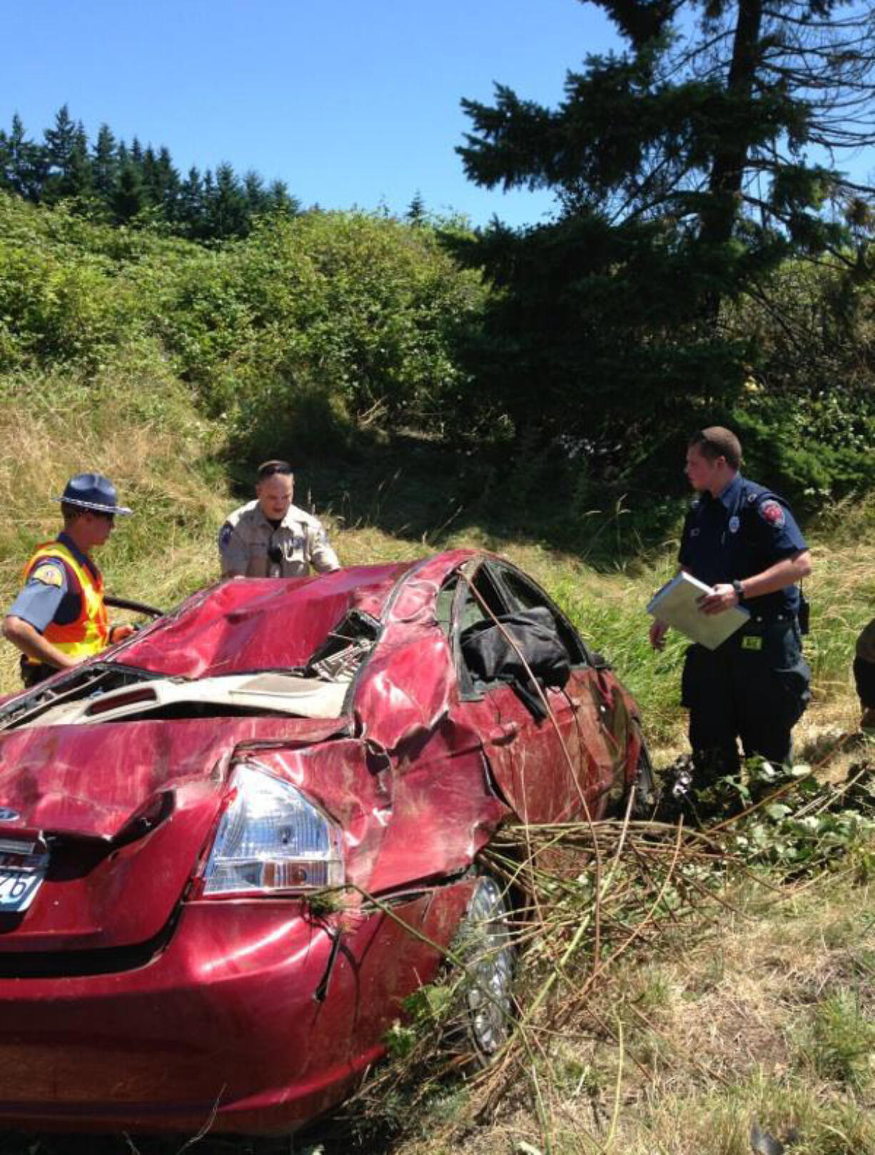 Firefighters and police couldn't locate the driver of this stolen Kia sedan after it crashed alongside Interstate 5 and caught on fire.