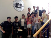 Battle Ground: A delegation of visitors from Gosen, Japan, including the mayor and six students, tours the Battle Ground Police Department on Aug.