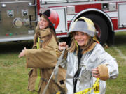 Warrenton, Ore.: Kiara Campbell-Burgess, left, and Kaylie Babcock, both from Vancouver, participate in a firefighting activity on July 30 while attending Camp Rosenbaum in Warrenton, Ore.