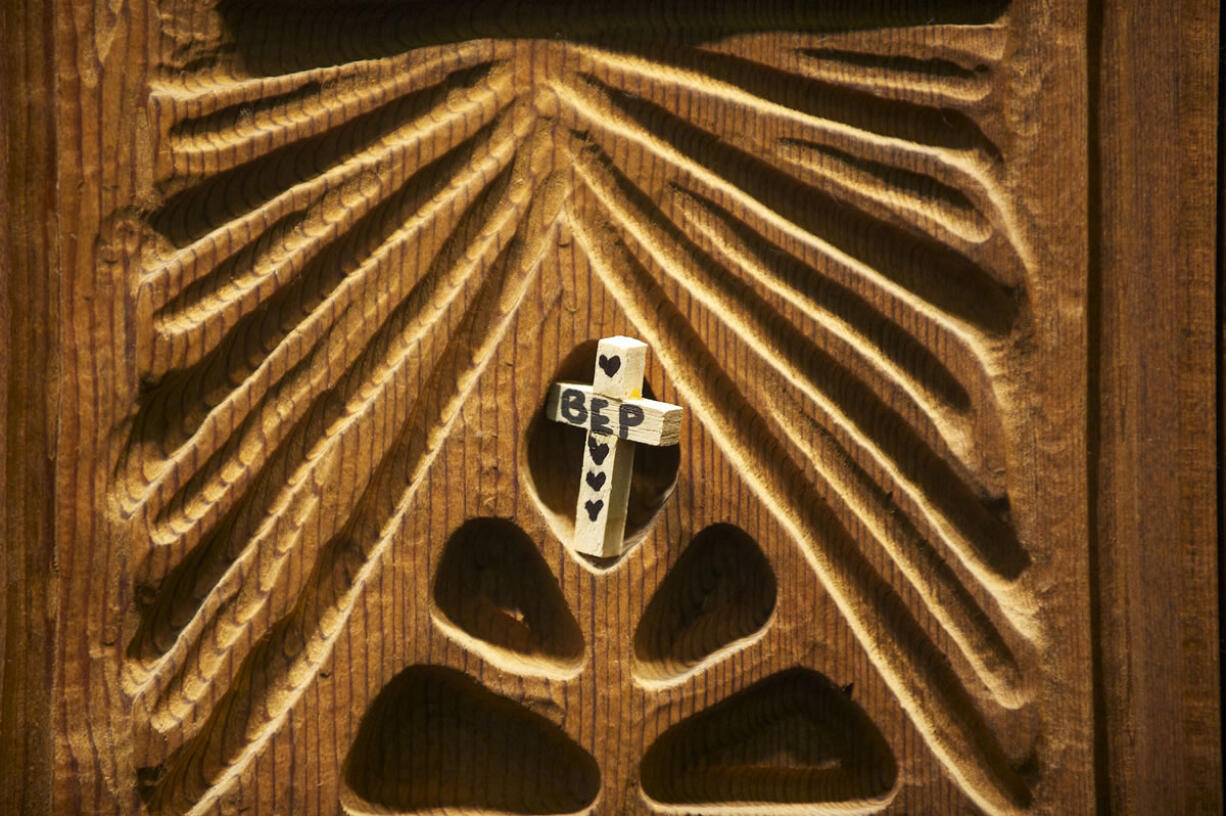 A cross is placed along with others on wooden panels March 13 at Heritage Chapel at PeaceHealth Southwest Medical Center in Vancouver.