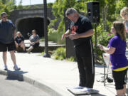 Washougal Mayor Sean Guard weighs in as Camas Mayor Scott Higgins, left, looks on Saturday at the final weigh-in for the &quot;Camas and Washougal on a Diet&quot; challenge.  Both mayors, along with 450 residents, took part in the yearlong project.