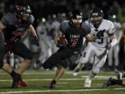 Camas running back Nate Beasley (7) carries ball against Arlington during Saturday's 4A state football playoff game.