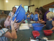 Julia Ritton, 7, of Battle Ground can't resist a taste of raspberry freezer jam that she made Sunday during Homestead Day at the Venersborg School house.