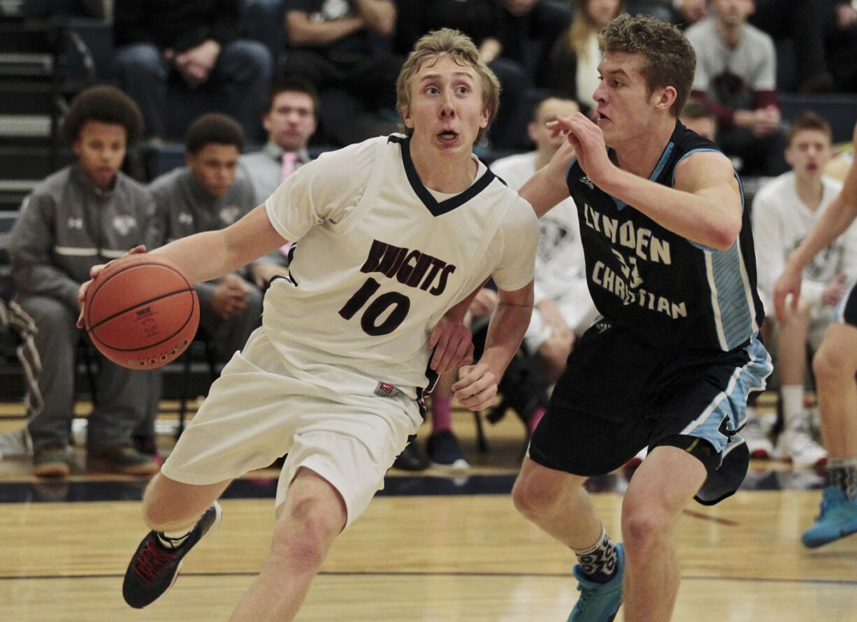 King&#039;s Way Christian guard Skyler Freeman (10) drives against Lynden Christian&#039;s Nate Hielkema (right) during the Knights&#039; 60-51 loss Tuesday.