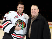 Mac Carruth, left, is congratulated by Darrell May, Sr., on Wednesday after Carruth passed May for the franchise record for wins by a goalie.