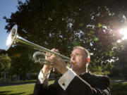 Main photo by Troy Wayrynen/The Columbian
Bruce B. Dunn, trumpeter and music educator with the Vancouver Symphony Orchestra, plays in Vancouver's Esther Short Park.