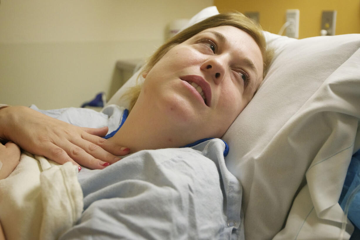 Laina Harris answers a nurses questions before undergoing gallbladder surgery at PeaceHealth Southwest Medical Center on July 5.