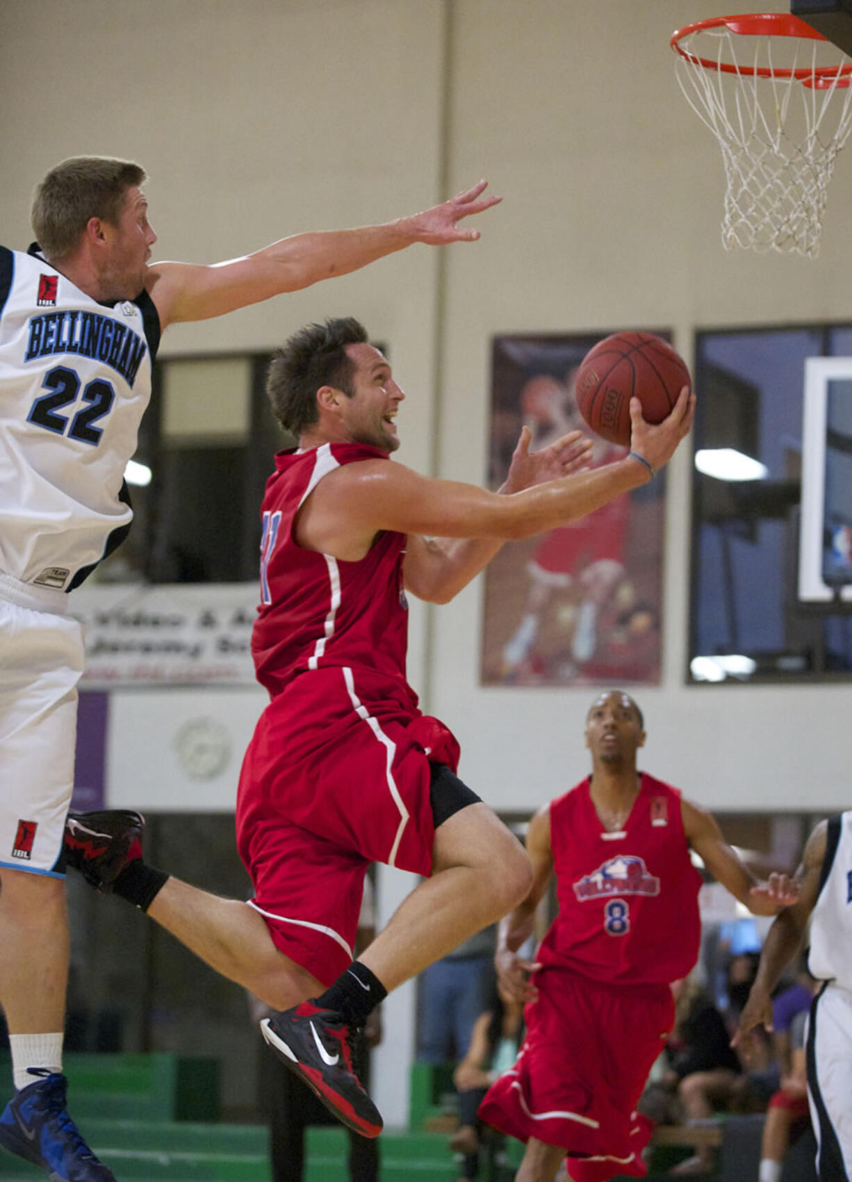 Vancouver Volcanoes Paul Hafford drives to the basket against Bellingham Slam's Jacob Stevenson (22) during the IBL championship game Friday.