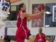 Vancouver Volcanoes Paul Hafford drives to the basket against Bellingham Slam's Jacob Stevenson (22) during the IBL championship game Friday.