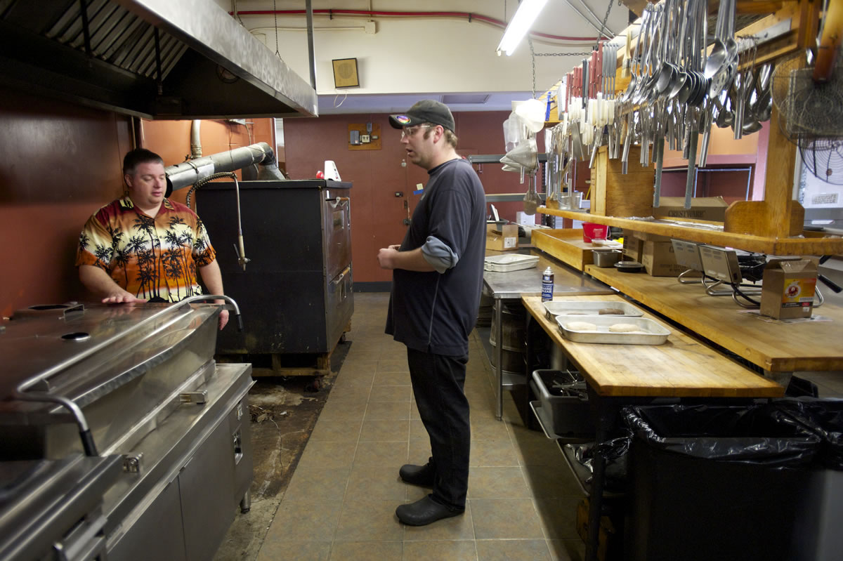 Larry Bowman, general manager of the Oak Tree Restaurant, left, talks with cook Brian Hansen about kitchen layout.