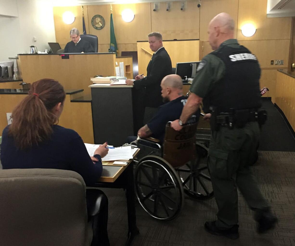 Douglas Atkins, 41, of Vancouver makes a first appearance Thursday in Clark County Superior Court after he allegedly led officers on a pursuit and crashed into parked cars, a portion of a house and an apartment complex late Wednesday night.