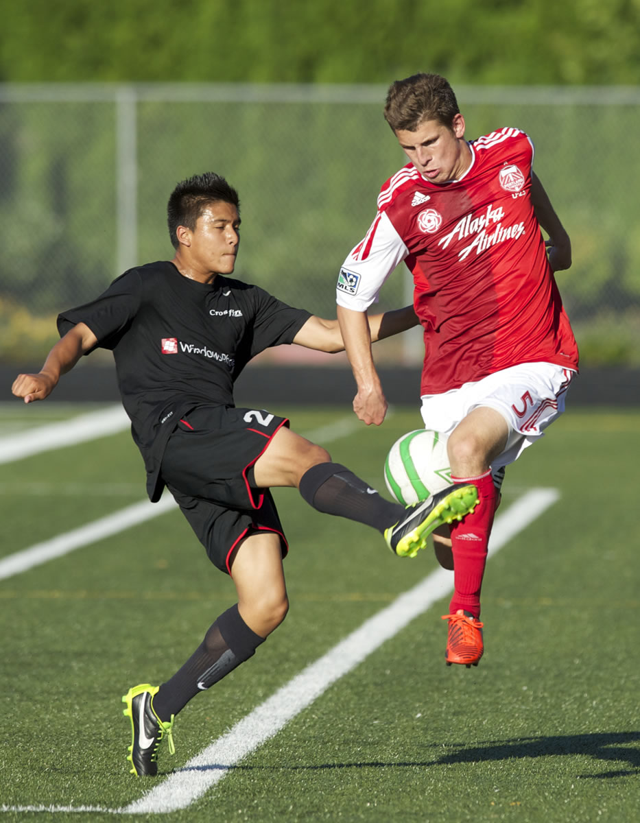 Portland Timbers U-23 player Mitch Lurie (5) fights for the ball with Washington Crossfire's Chaz Jenkins at Doc Harris Stadium on Friday.