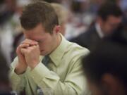 Jeff Miller, 23, of Washougal, prays during the Clark County Mayors' and Civic Leaders' 11th Annual Prayer Breakfast at the Hilton Vancouver Washington on Friday.