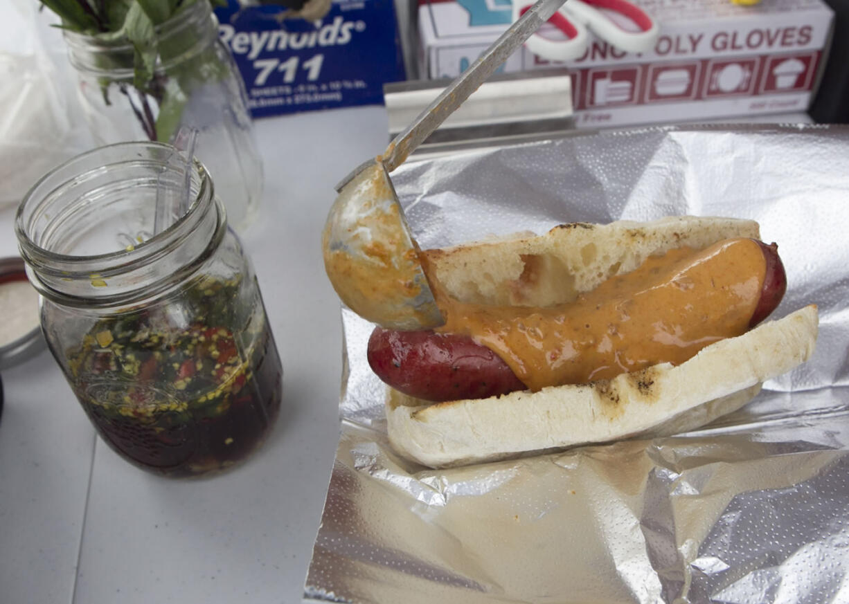 A Thai curry dog with panang curry, Thai basil and a homemade chili sauce is served Feb. 10 at the Nomad food cart in Vancouver.