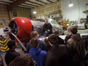 Pearson Air Museum director Laureano Mier tells students in David Richards' metal-fab class at Fort Vancouver High School how career training can pay off in the working world.