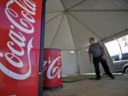 Greg Taylor looks over a booth filled with Coca-Cola products while in the process of setting up for the Clark County Fair.