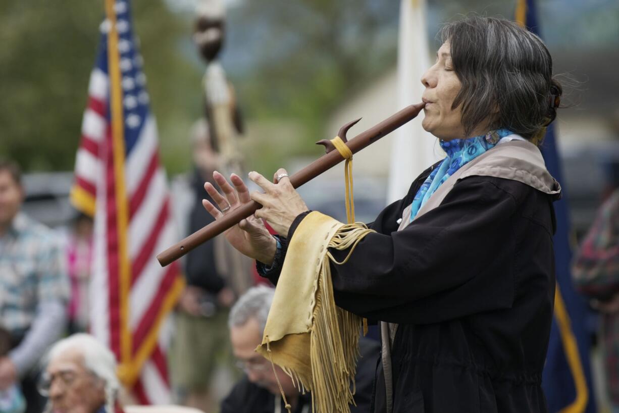 Katherine Quartz, from the Walker River Paiute tribe, plays a flute song titled &quot;Waterflow&quot; to honor the infant son of Little Bear during the 16th annual Nez Perce Chief Redheart Memorial Ceremony at the Fort Vancouver National Historic Reserve on Saturday.