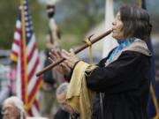 Katherine Quartz, from the Walker River Paiute tribe, plays a flute song titled &quot;Waterflow&quot; to honor the infant son of Little Bear during the 16th annual Nez Perce Chief Redheart Memorial Ceremony at the Fort Vancouver National Historic Reserve on Saturday.