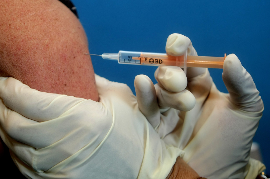 A flu vaccine is administered.