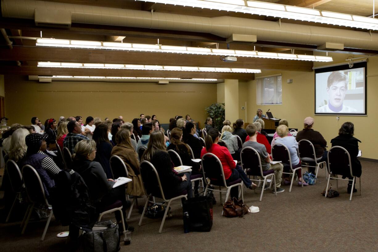 The audience at the workshop watches a video of a convicted sex offender who was a minister in Arkansas, explaining how he got away with committing about 90 offenses.