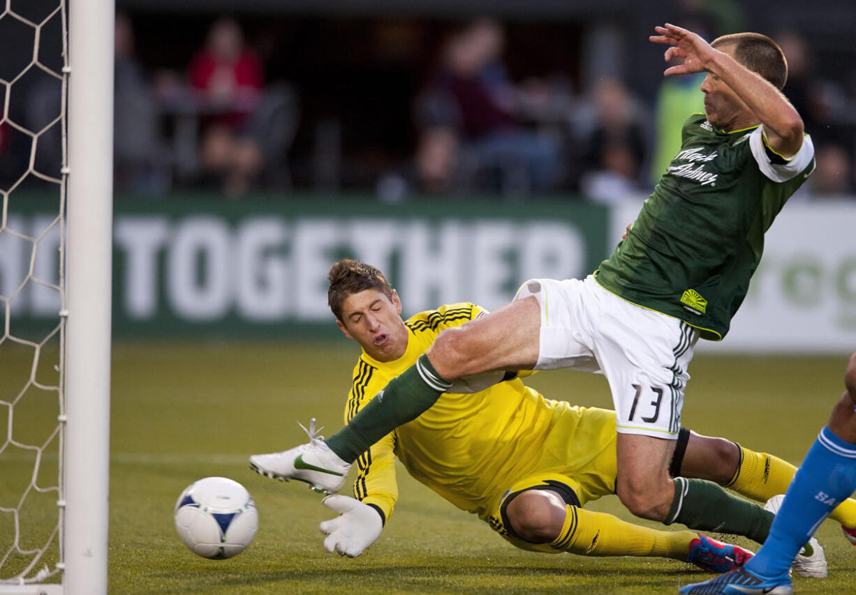 Portland's Jack Jewsbury lunges to beat San Jose goalkeeper David Bingham to the ball, scoring his first goal of the season.