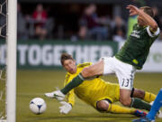 Portland's Jack Jewsbury lunges to beat San Jose goalkeeper David Bingham to the ball, scoring his first goal of the season.