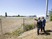 Troy Drawz, left, and Roy Johnson of the Vancouver Housing Authority look over the site where the VHA has proposed to build 152 units of low-income apartments, just east of 164th Avenue on Southeast First Street.