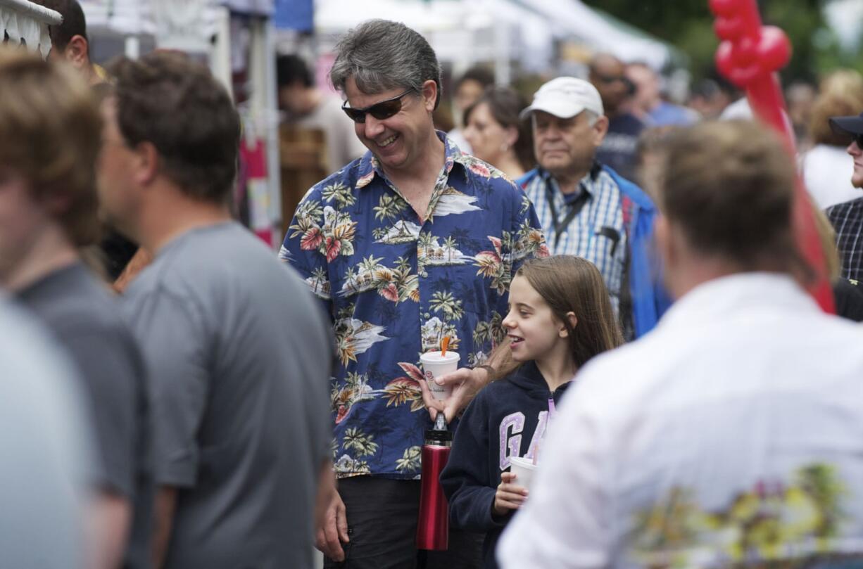 Elyse Degerstedt, 11, has lots of nice things to say about her dad, Neil Degerstedt, as they shop at the market.