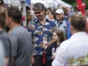 Elyse Degerstedt, 11, has lots of nice things to say about her dad, Neil Degerstedt, as they shop at the market.