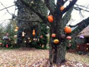 Ridgefield -- Neighbors, friends and families helped Kara Breuer with her eight-year tradition of hanging pumpkins and gourds from trees in her front yard.