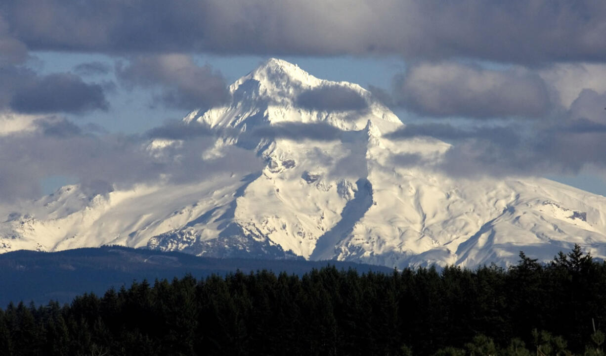 Clouds flit across the west face of Mount Hood as seen near Boring, Ore., in February 2010. An El Nino-like winter could put a dent in typical snow packs by spring.