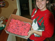 Central Park: Hunter Simpson shows a few of the 140 dozen cookies baked by Red Cross Youth members.