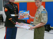 Walnut Grove: Christian Davison, senior patrol leader of Boy Scouts of America Troop 328, gives toys Dec. 17 to Cpl. Sean Houston. The toys were collected for the U.S.