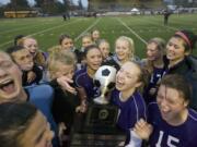 Columbia River players celebrate their 3A state soccer championship after defeating Mount Spokane 2-1 on Saturday at Sparks Stadium in Puyallup.